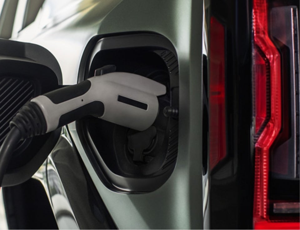 Close up of charging port with charger plugged in on a GMC Hummer EV SUV - Lake GMC in Lewistown PA